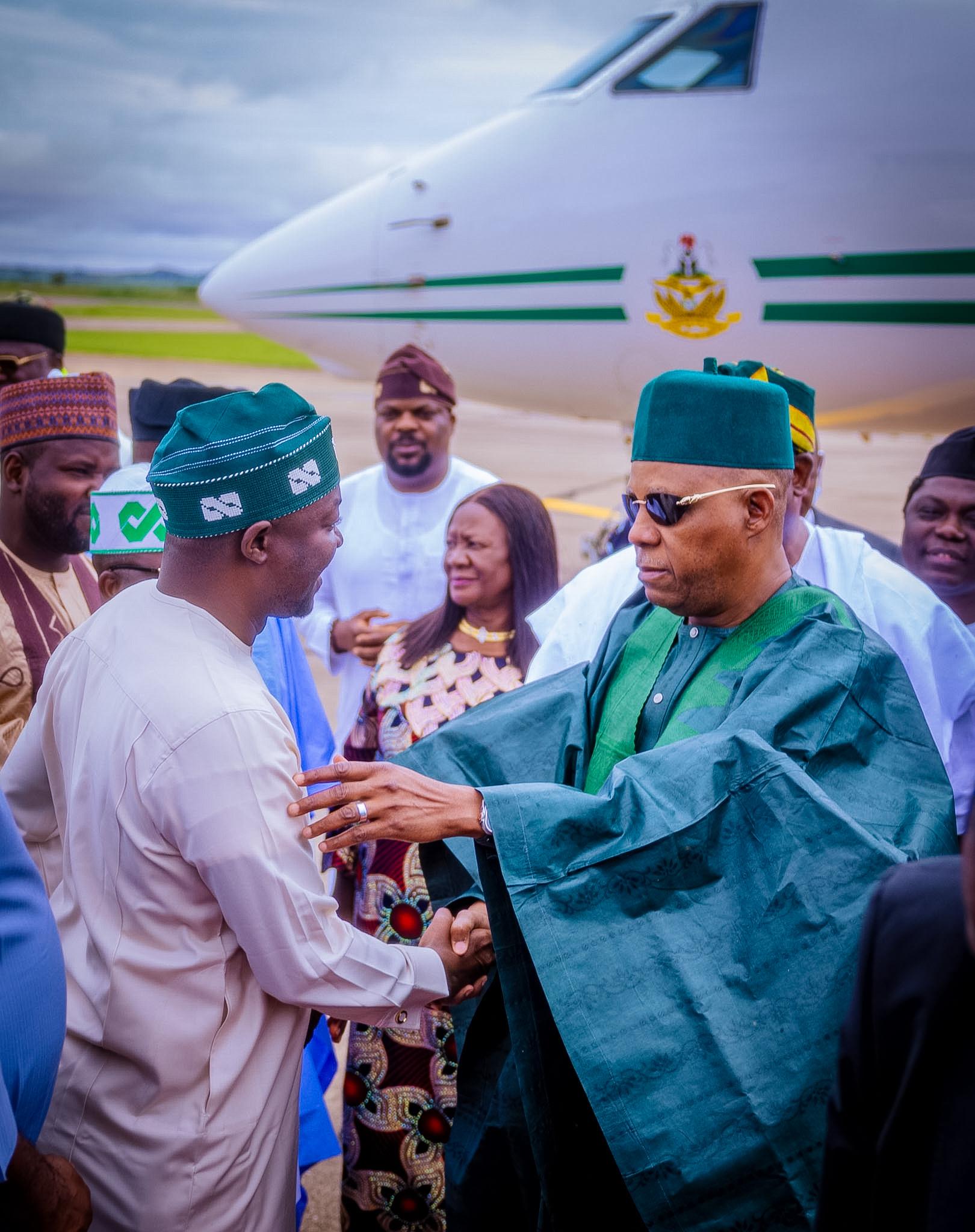 Barji greeting a dignitary near an aircraft
