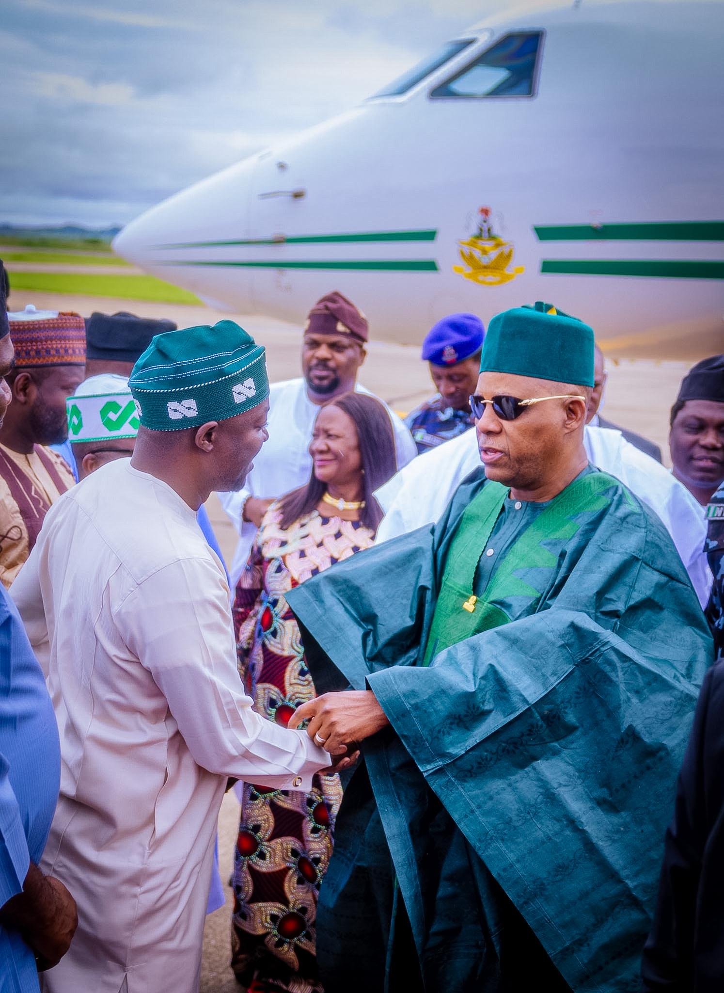 Barji greeting a dignitary near an aircraft