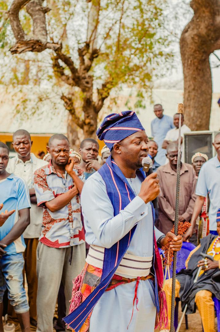Barji speaking into a microphone outdoors