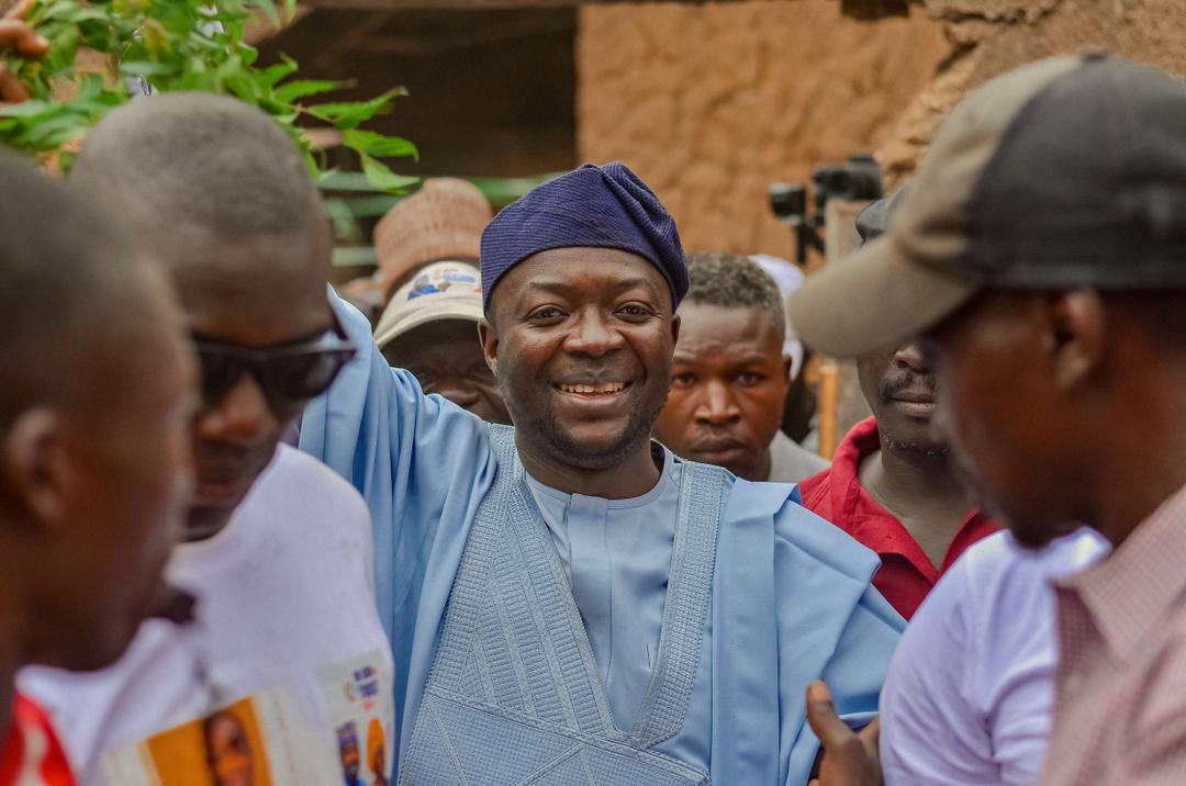 Barji smiling among a crowd of supporters